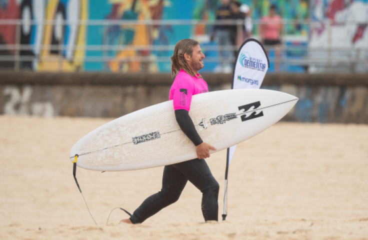 World Surfing Champion Mark Occhilupo running on sand